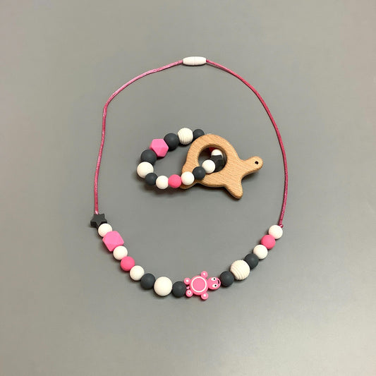 Collier en silicone fait avec plusieurs billes en silicones de différentes couleurs, tailles et formes, et il est complété par une attache en plastique.   Hochet d'éveil en silicone fait avec plusieurs billes en silicones de différentes couleurs et différentes tailles avec une plus gros jouet de dentition.