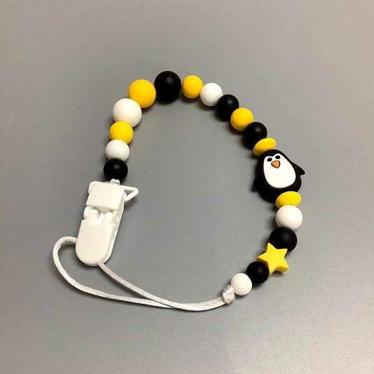 Silicone pacifier clip - Black penguin and yellow ball