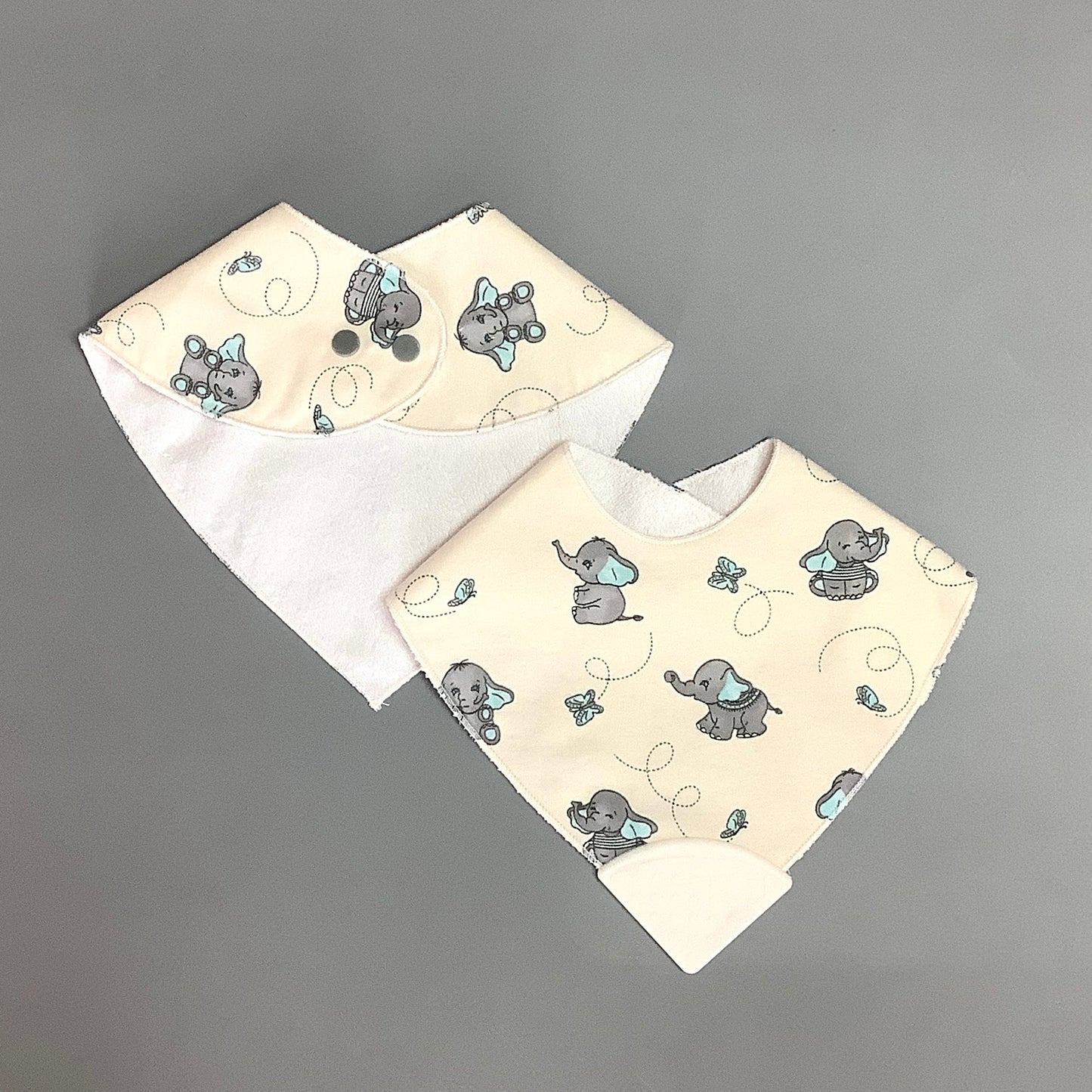 Blue elephant teething bib on beige background