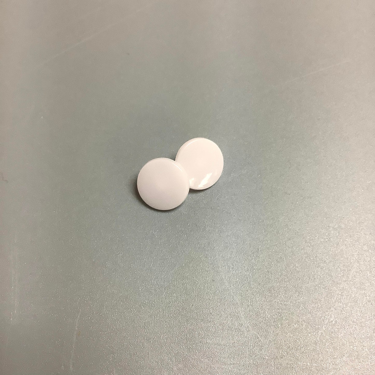 Pink elephant teething bib on beige background