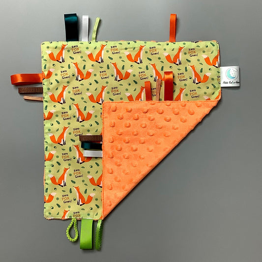 Doudou Calyn  pour les enfants   Fait en coton et avec du polars flanelle (notre tissu à doudou super doux), avec différents rubans.   Chaque doudou est fait au Québec et est unique.   Doudou : 12'' x 12''